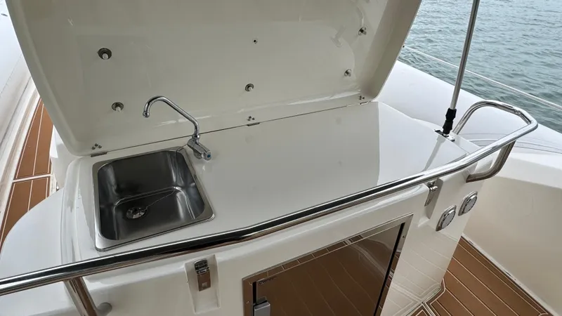 Hoko Yacht Photos Pics 2017 Nuova Jolly Princess yacht kitchenette with sink and storage, overlooking the water.