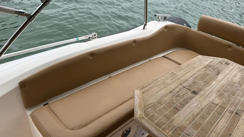 Hoko Yacht Photos Pics 2017 Nuova Jolly Princess boat interior with beige seating and wooden table.
