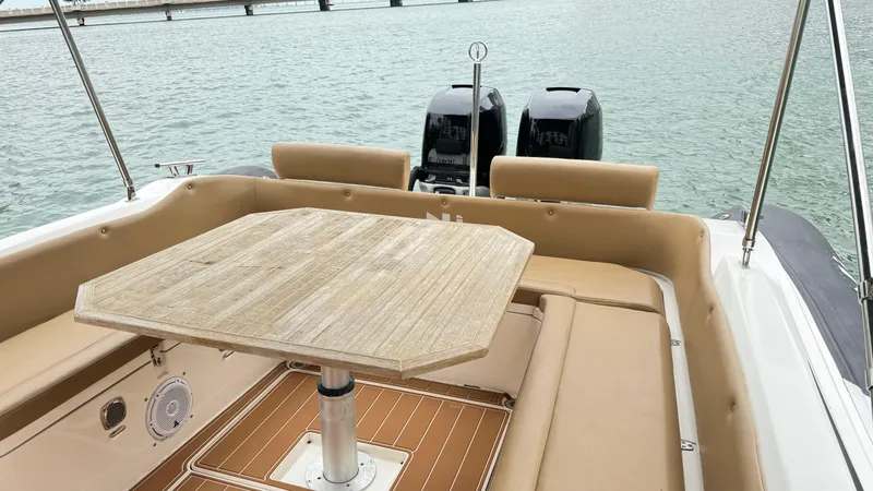 Hoko Yacht Photos Pics 2017 Nuova Jolly Princess boat interior with table and seating, overlooking water.