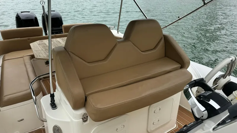 Hoko Yacht Photos Pics 2017 Nuova Jolly Princess boat interior with tan seating and wooden deck.