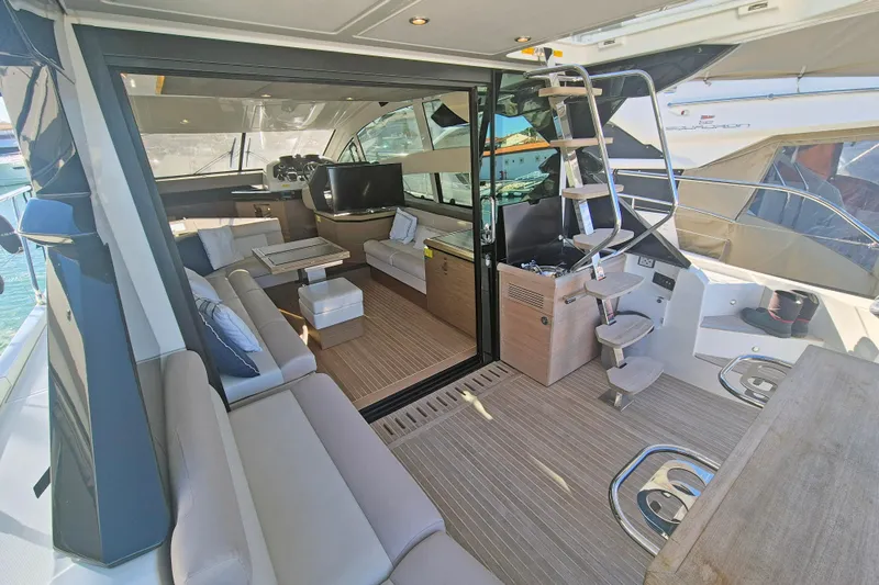  Yacht Photos Pics Luxurious interior of 2019 Beneteau Gran Turismo 50 Sportfly yacht with modern seating and staircase.