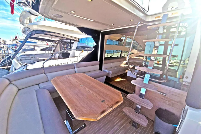  Yacht Photos Pics Luxurious 2019 Beneteau Gran Turismo 50 Sportfly yacht interior with elegant seating and wooden table.