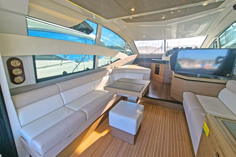 Yacht Photos Pics Luxurious interior of 2019 Beneteau Gran Turismo 50 Sportfly yacht with modern seating and helm.
