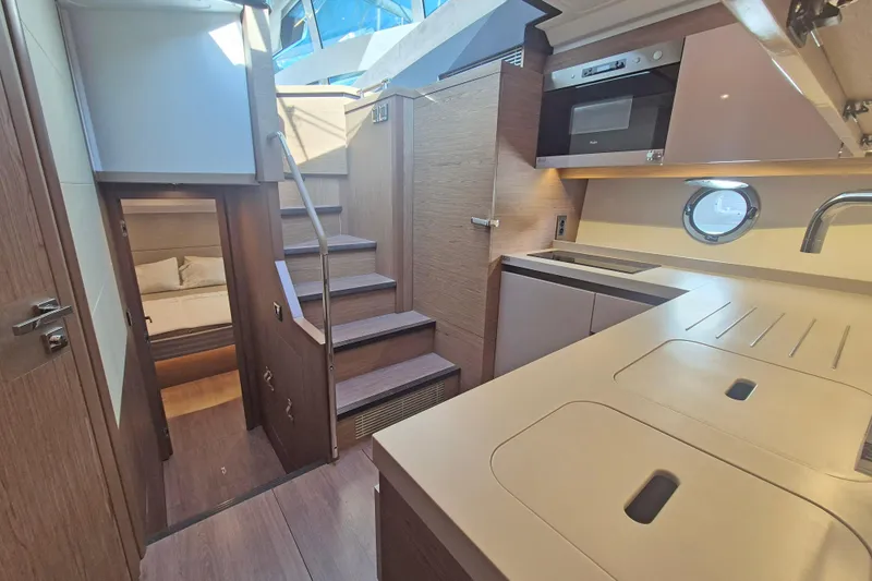  Yacht Photos Pics Interior of 2019 Beneteau Gran Turismo 50 Sportfly yacht, featuring modern kitchen and cozy cabin.