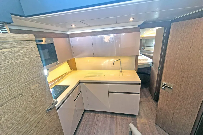  Yacht Photos Pics 2019 Beneteau Gran Turismo 50 Sportfly yacht interior kitchen with modern design and sleek cabinetry.