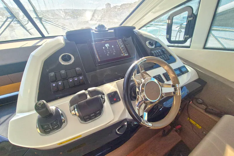 Yacht Photos Pics 2019 Beneteau Gran Turismo 50 Sportfly helm with modern controls and navigation display.