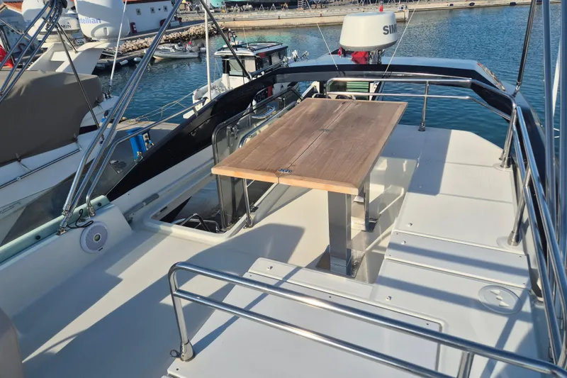  Yacht Photos Pics 2019 Beneteau Gran Turismo 50 Sportfly deck with table, docked at marina.