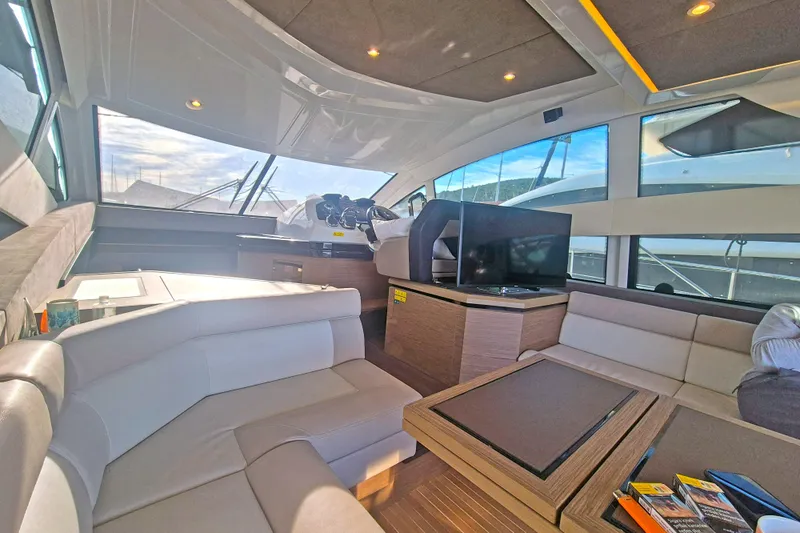  Yacht Photos Pics Luxurious interior of 2019 Beneteau Gran Turismo 50 Sportfly yacht with modern seating and TV.