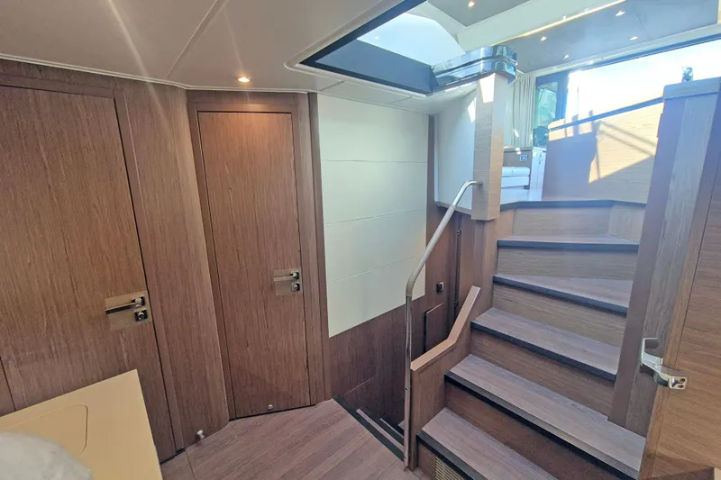  Yacht Photos Pics Interior of 2019 Beneteau Gran Turismo 50 Sportfly with wooden stairs and doors.