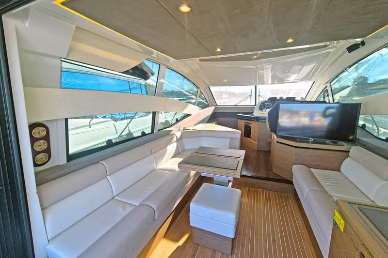  Yacht Photos Pics Luxurious interior of 2019 Beneteau Gran Turismo 50 Sportfly yacht with modern seating and TV.