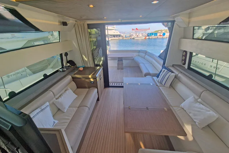  Yacht Photos Pics Luxurious interior of 2019 Beneteau Gran Turismo 50 Sportfly yacht with elegant seating and wood finishes.