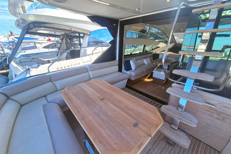  Yacht Photos Pics Luxurious interior of 2019 Beneteau Gran Turismo 50 Sportfly yacht with elegant seating and wooden table.