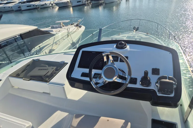  Yacht Photos Pics 2019 Beneteau Gran Turismo 50 Sportfly helm with modern controls and marina view.