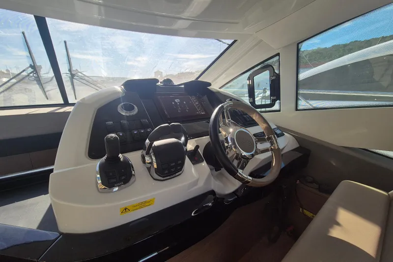  Yacht Photos Pics Interior helm of 2019 Beneteau Gran Turismo 50 Sportfly yacht, featuring modern controls.