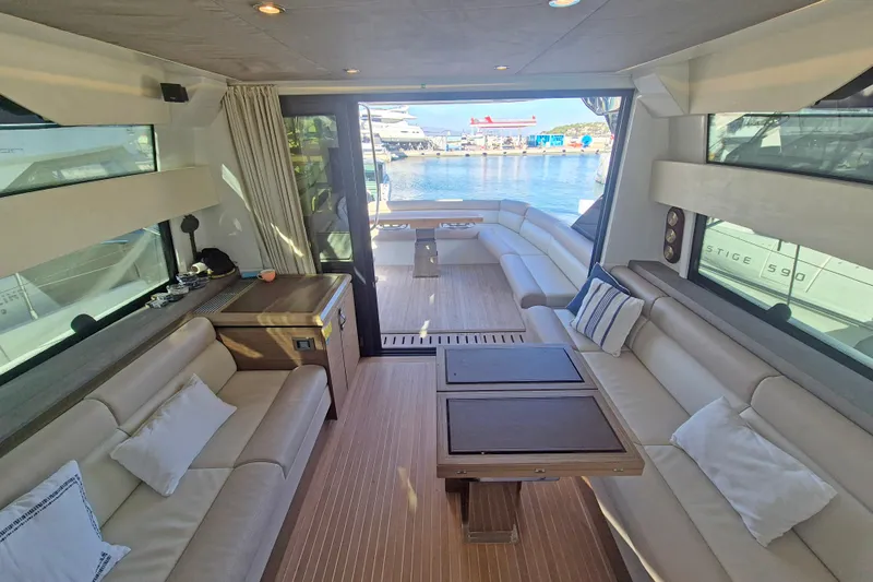  Yacht Photos Pics Luxurious interior of 2019 Beneteau Gran Turismo 50 Sportfly yacht with elegant seating and waterfront view.