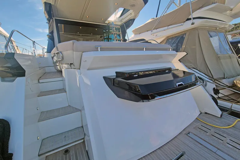  Yacht Photos Pics 2019 Beneteau Gran Turismo 50 Sportfly yacht, rear view with stairs and seating area.