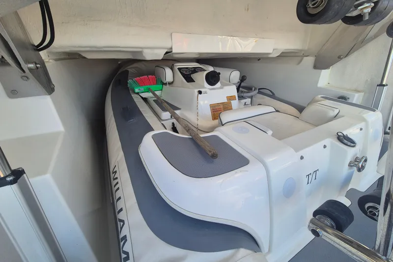  Yacht Photos Pics 2019 Beneteau Gran Turismo 50 Sportfly with stored inflatable boat in compartment.