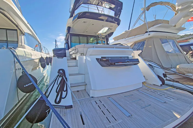  Yacht Photos Pics 2019 Beneteau Gran Turismo 50 Sportfly yacht docked, showcasing rear deck and stairs.