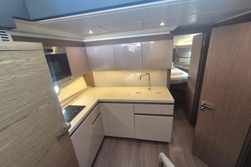  Yacht Photos Pics 2019 Beneteau Gran Turismo 50 Sportfly yacht kitchen with modern cabinetry and appliances.