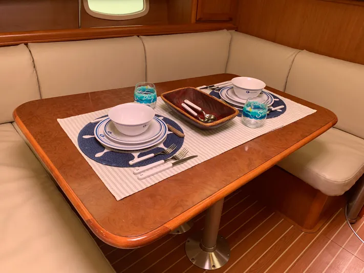Flote About Yacht Photos Pics Elegant dining setup in 2009 Hunter 45 Deck Salon yacht interior.