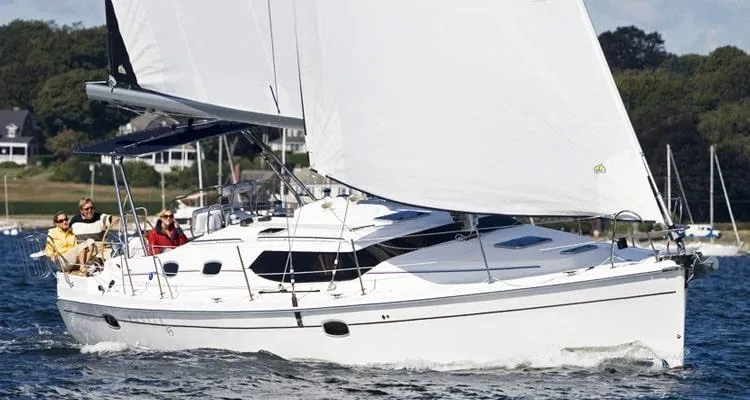 Flote About Yacht Photos Pics 2009 Hunter 45 Deck Salon sailing on a sunny day with passengers onboard.