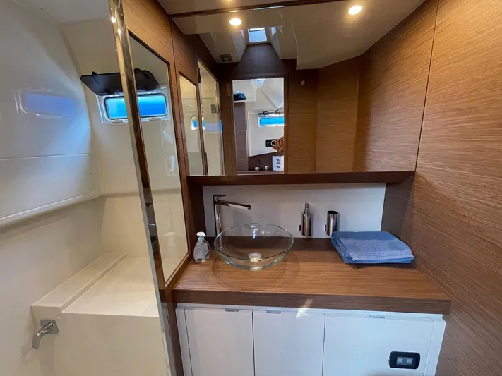  Yacht Photos Pics Luxurious bathroom interior of 2023 Solaris Power 44 Open yacht with modern fixtures.