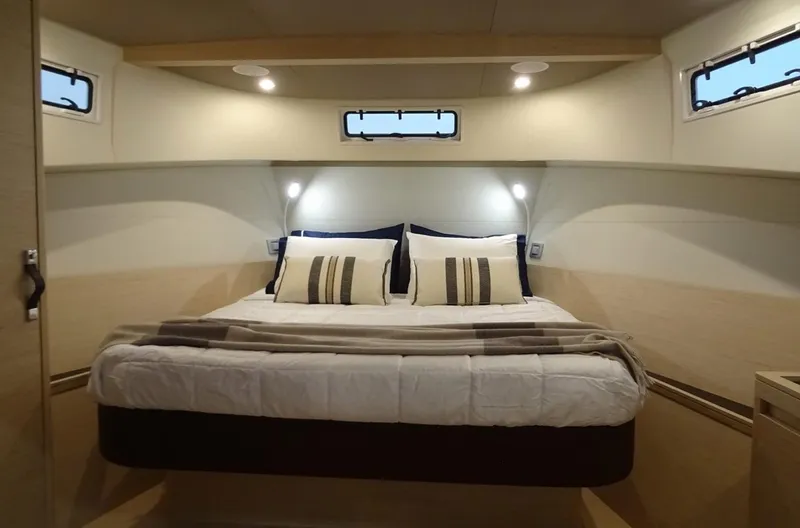  Yacht Photos Pics Luxurious cabin interior of 2023 Solaris Power 44 Open yacht with cozy bedding.