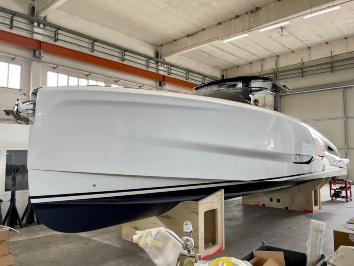 Yacht Photos Pics 2023 Solaris Power 44 Open yacht in a warehouse, showcasing sleek design and modern features.