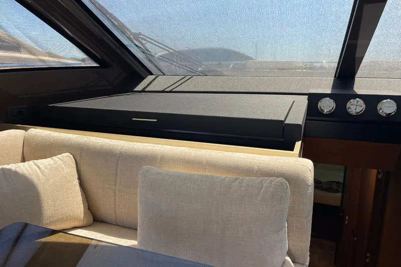  Yacht Photos Pics Interior of 2025 Ferretti Yachts 670 with plush seating and modern dashboard.