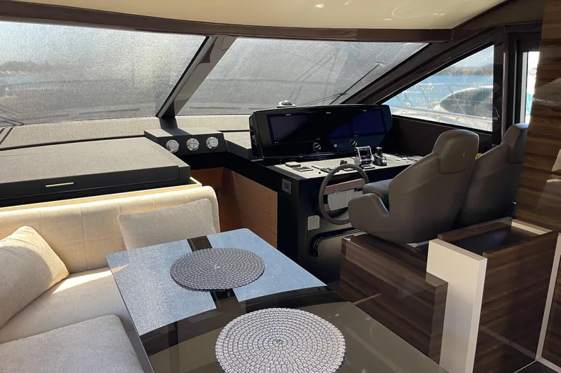  Yacht Photos Pics Luxurious interior of 2025 Ferretti Yachts 670, featuring modern helm and elegant seating area.