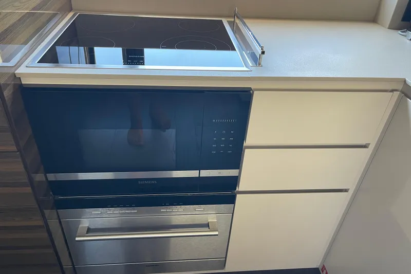  Yacht Photos Pics Modern kitchen appliances in 2025 Ferretti Yachts 670, featuring Siemens oven and stovetop.