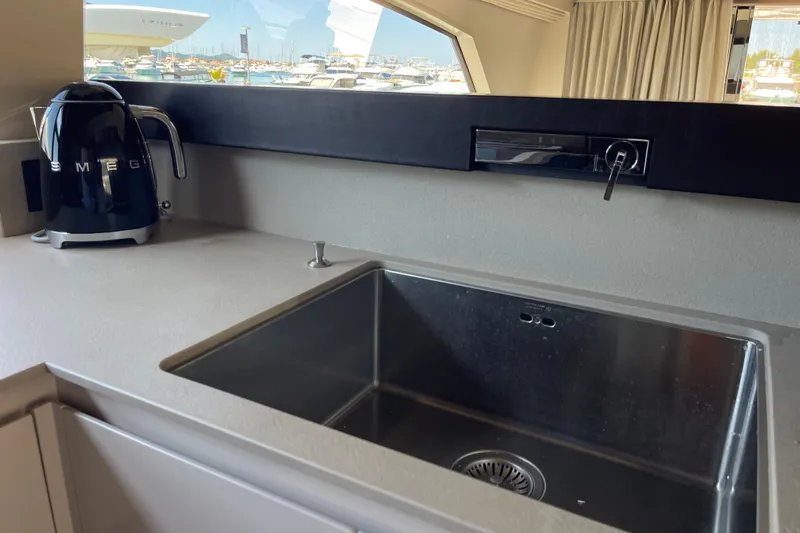  Yacht Photos Pics Modern kitchen sink area on 2025 Ferretti Yachts 670 with Smeg kettle.