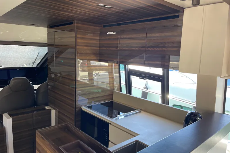  Yacht Photos Pics Luxurious interior of 2025 Ferretti Yachts 670, featuring sleek wood finishes and modern design.