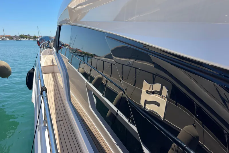  Yacht Photos Pics 2025 Ferretti Yachts 670, sleek design, docked on calm waters, reflecting clear blue sky.