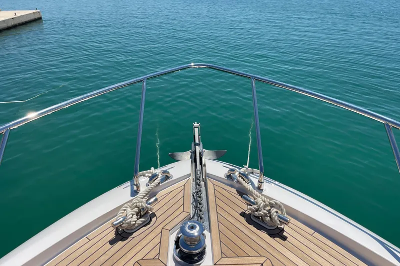  Yacht Photos Pics Bow view of 2025 Ferretti Yachts 670 on calm blue water.
