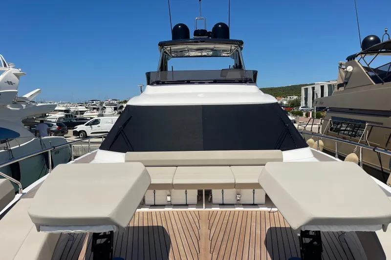  Yacht Photos Pics 2025 Ferretti Yachts 670, luxury yacht with sunbathing area, docked in marina.