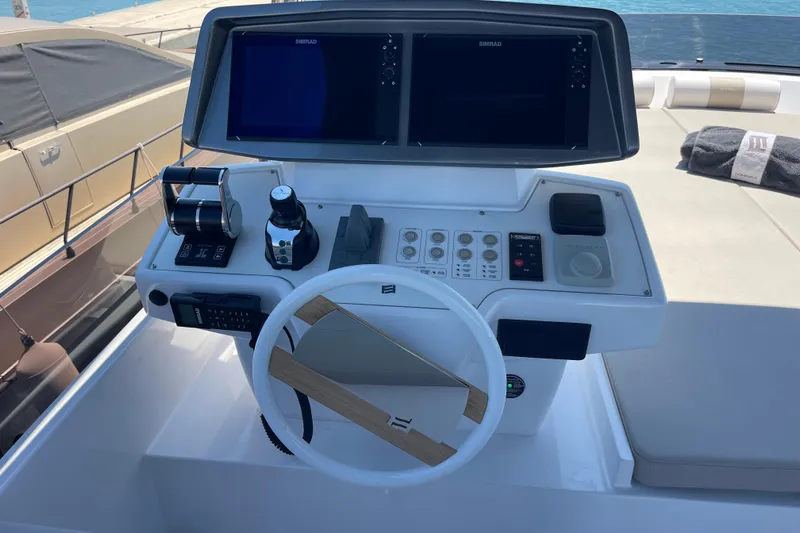  Yacht Photos Pics Cockpit of 2025 Ferretti Yachts 670 with modern navigation controls and dual screens.