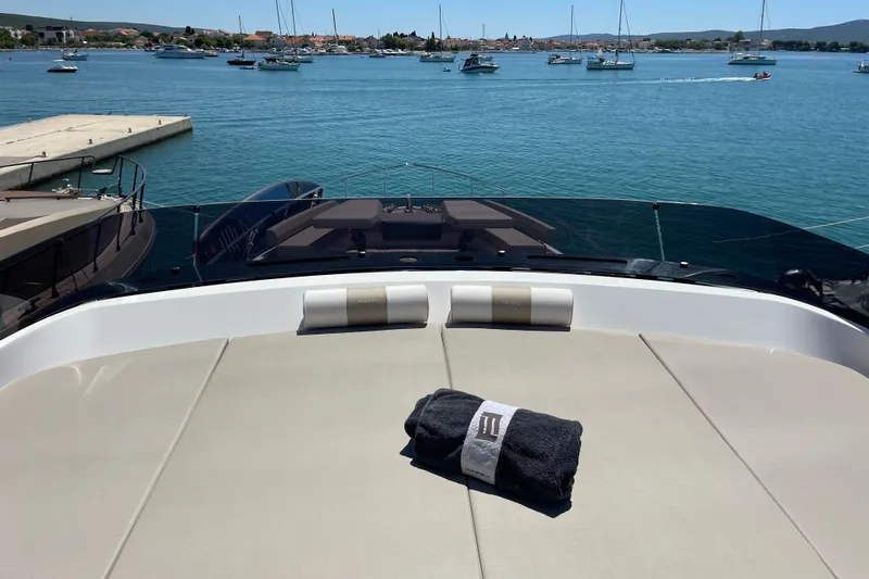  Yacht Photos Pics Luxurious 2025 Ferretti Yachts 670 with sun deck, overlooking serene marina waters.
