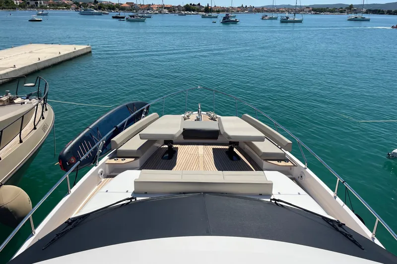  Yacht Photos Pics Luxurious 2025 Ferretti Yachts 670 docked, featuring spacious deck and scenic ocean view.