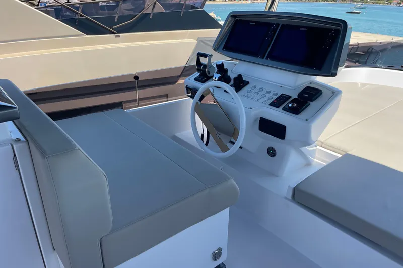  Yacht Photos Pics Modern helm station of 2025 Ferretti Yachts 670 with dual screens and sleek design.