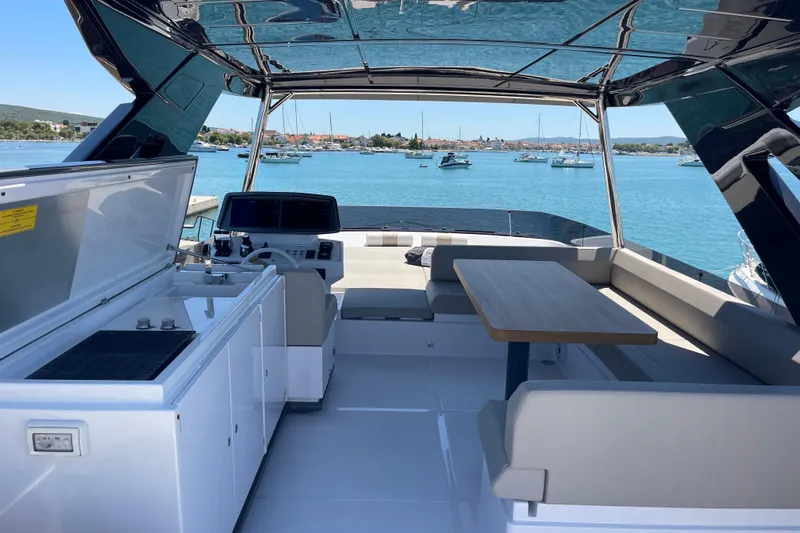  Yacht Photos Pics Luxurious 2025 Ferretti Yachts 670 interior with seating, table, and ocean view.