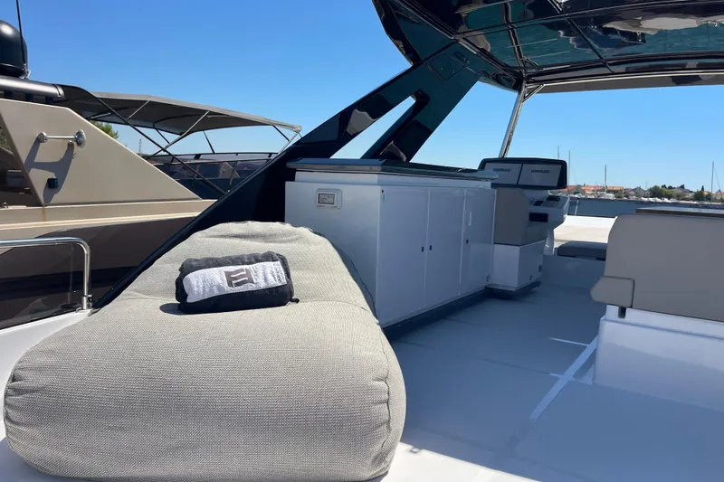  Yacht Photos Pics Luxurious 2025 Ferretti Yachts 670 deck with modern seating and navigation equipment.