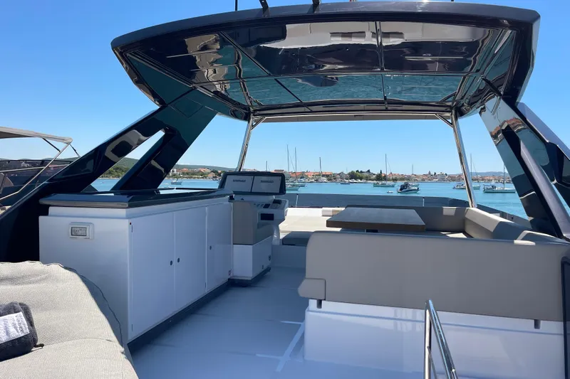  Yacht Photos Pics Luxurious 2025 Ferretti Yachts 670 with sleek design and spacious deck overlooking marina.