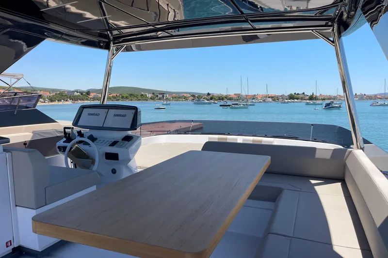  Yacht Photos Pics Luxurious 2025 Ferretti Yachts 670 with elegant seating and scenic ocean view.