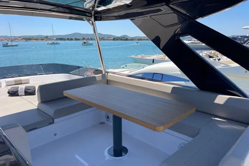  Yacht Photos Pics Luxurious 2025 Ferretti Yachts 670 with elegant seating and scenic ocean view.