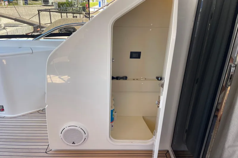  Yacht Photos Pics 2025 Ferretti Yachts 670 storage compartment with open door on deck.