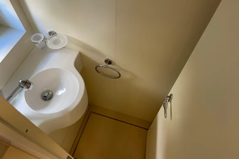  Yacht Photos Pics Compact bathroom in 2025 Ferretti Yachts 670, featuring modern sink and fixtures.