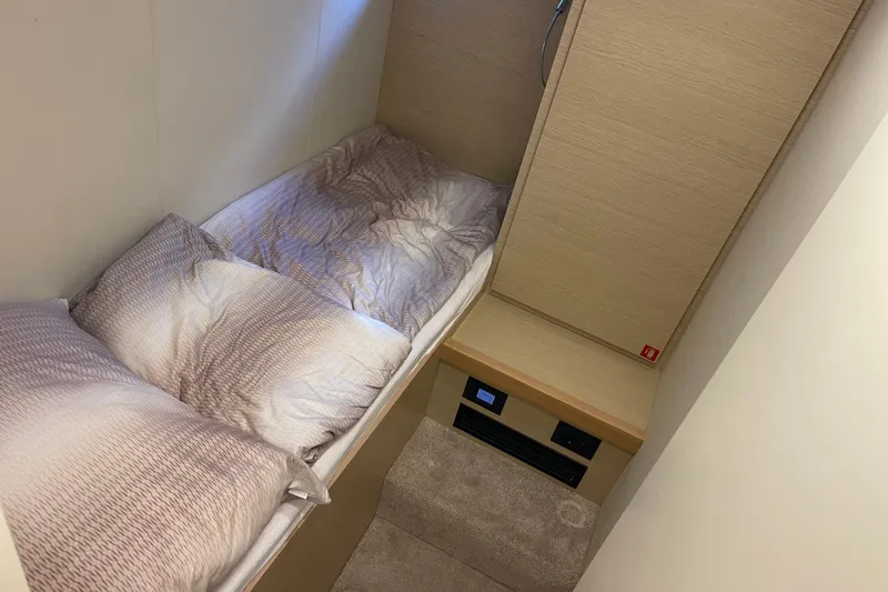  Yacht Photos Pics Cozy cabin interior of 2025 Ferretti Yachts 670 with plush bedding.