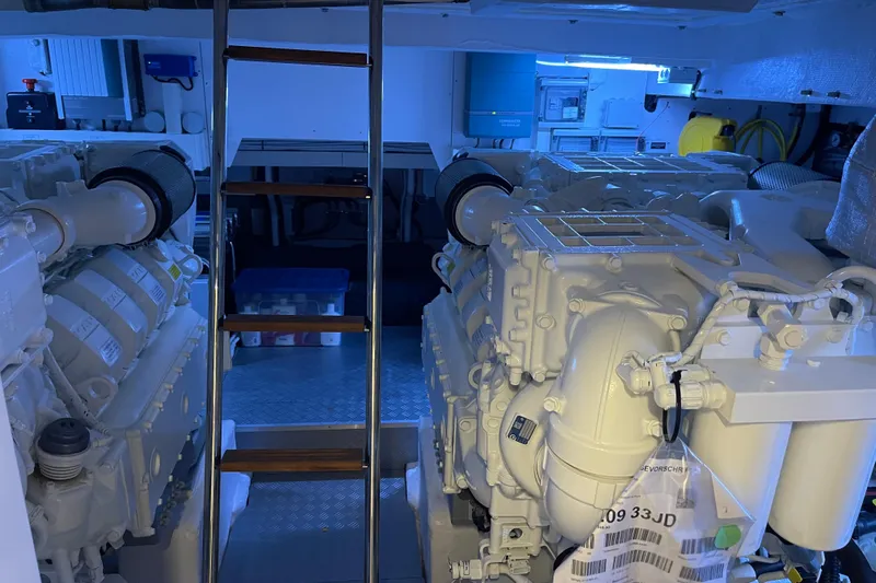  Yacht Photos Pics Engine room of 2025 Ferretti Yachts 670, featuring dual engines and a metal ladder.