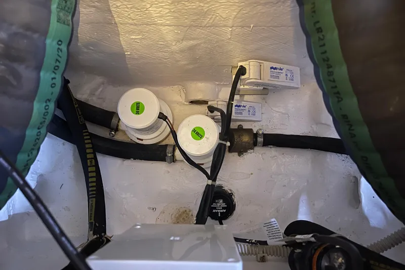  Yacht Photos Pics Engine room components of 2025 Ferretti Yachts 670, featuring hoses and electrical connections.